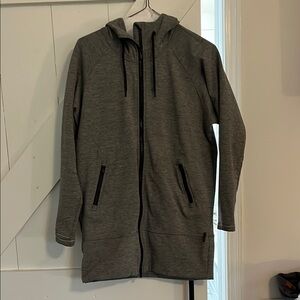 Athleta women’s gray hooded jacket. Has zip pockets and thumb holes. Size XS.